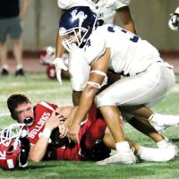 Mikey Devereaux knocked the helmet off this Cache running back 