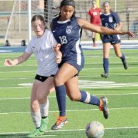 Madison Rochdi collides with a Guthrie defender while battling for control of the ball