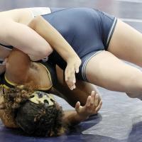 Seely Chronister hooks the arm of Midwest City’s Jackallyne Guzman