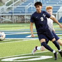 Carlos Garcia screens off an opponent as he tries to chase down a loose ball