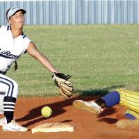 Izzy Choat has a pickoff throw glance off her glove as a Piedmont runner slides into the bag