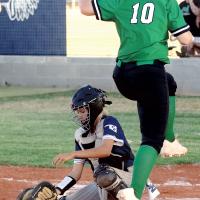 Maddy Brinkman blocks a low throw as a runner leaps over the plate