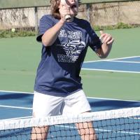 Devlon Galyon sets up for an overhand return shot at the net