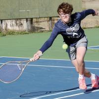 Jonathan Albrecht reaches out to hit a forehand return shot