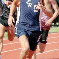 Ethan Brooks runs in his lane during the opening curve of the 3,200-meter run
