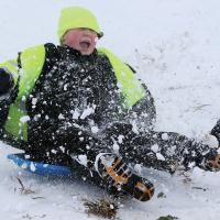 Ethan Lopez gets a face full of snow