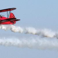 Three vintage bi-planes fly over the El Reno Regional Airport