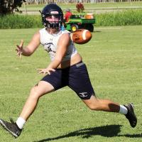 Aidan Dyer keeps his eyes on the ball as he stretches to catch a pass