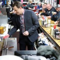 Todd Piro cracks an egg during a live shot at Sid’s Diner