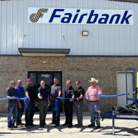 Steve Jensen, far right, helps officials with Fairbank cut the ribbon
