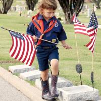 Dacien Finnigan carries an American flag 