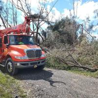 An OG&E truck helps clear damage and restore power in the wake of Hurricane Ian
