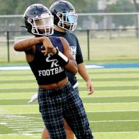 Quarterback Elijah Fisher throws a roll-out pass