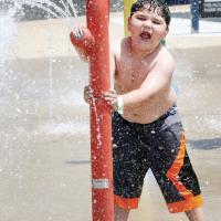 Anthony Gamboa sprays water out of a tube
