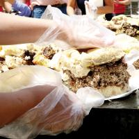 A volunteer picks up slices of the Big Burger