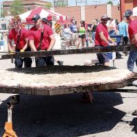 Members of the El Reno Fire Department place the top half of the skillet on the burger