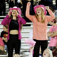 Conley Knapp, left, and Alexis Lively cheer on the Indians football team