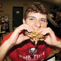 Aaron Ash of El Reno takes a huge bite of an onion-fried burger