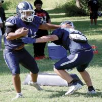 Glenn Boese throws a stiff arm during a recent practice