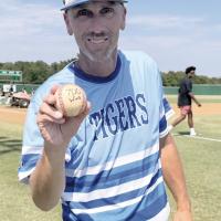 Ludy Griggs holds up the ball from his 700th career coaching victory