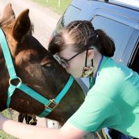 Hannah Wallace kisses Pollo on the forehead