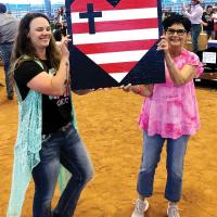 Sierra Wilson, left, with Laura O’Hara show off one of the class projects