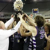 Okarche team members celebrate by holding up the Class A state title trophy