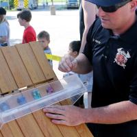 Sgt. David Baker places one of the cars on the wooden track