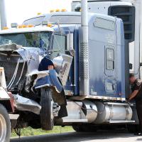 Andy Myers looks over the damage to this semi-truck