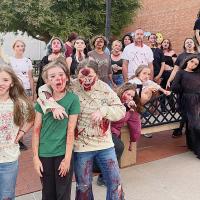 Cast members prepare to scare another trolley full of riders