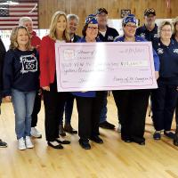 Members of the Power of 100 stand with representatives of VFW Post 382