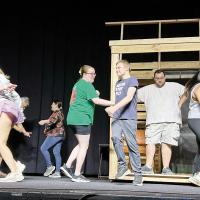 The cast of Bright Star rehearse on stage at the Centre Theatre