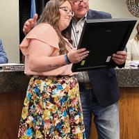Steve Jensen reads the proclamation honoring Sgt. Thomas Duran as the wife of the late El Reno officer stands at his side
