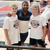 Tyrone Lewis poses for a photo with Dailey Jennings (left) and Will Heger