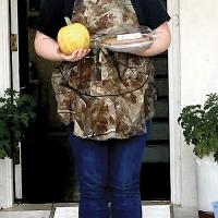 Kylista Burton holds one of the pumpkins and a pie that BlueSTEM students made
