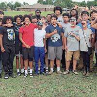Connie Holt and husband, Bob Ballhorn (front row gray shirts) got help from the EHS football team