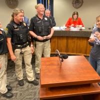 Dorrie Parrott presents the Golden Paw award to ACO members, from left, April Williams, Liz Hodgson and Shilo Powers