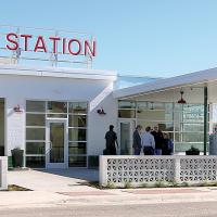 People begin to gather at The Filling Station before the ceremonial ribbon-cutting