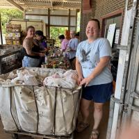Volunteers unload and sort donated food