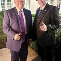 Donald Trump and Chris West pose for a photo in the Rose Garden