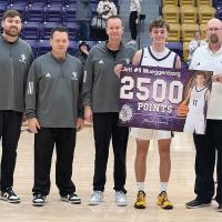 Jett Mueggenborg was presented a poster for passing 2,500 career points