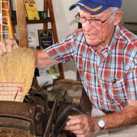J.D. Miller shows how to adjust his broom-making machine
