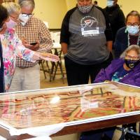 People gather around the blanket of Chief White Antelope