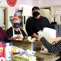 Mobile Meals volunteers put on party hats last week to celebrate