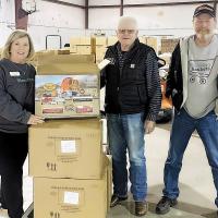 Curtis Blanc, Donna Dyer and Dan Hogan look over toy trains