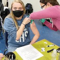 Allison Atchison gets a dose of the COVID-19 vaccine