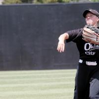 Iliana Ashford makes a throw toward first