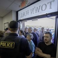Members of a standing-room only crowd file into the Inola Town Council meeting