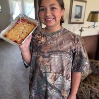 Isabelle Pena proudly shows off the cobbler she made for Grandma