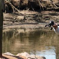 Water flings off the end of the lure on Isiah Deleon's fishing pole